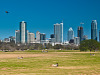 austin-downtown > Skyline of Austin Downtown as viewed from the kite field in Zilker park.