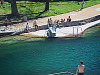 austin-downtown > A man jumps into the pool of Barton Springs in Austin, Texas