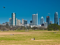 austin-downtown > Skyline of Austin Downtown as viewed from the kite field in Zilker park.