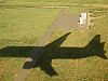 big-island-hawaii > plane landing shadow grass denver airport