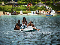 big-island-hawaii > Boys and girls floating on a pedalo in the Waikoloa Village lagoon