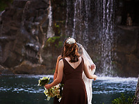 big-island-hawaii > Bride and maids in front of waterfall in Waikoloa Village