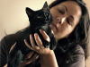 black-cute-cat > Cat held in hands