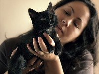 black-cute-cat > Cat held in hands