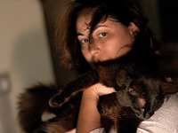 black-cute-cat > Cat held in arms