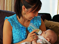 pflugerville-texas > Friend giving milk to baby at baby shower