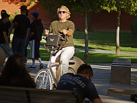 san-jose-state > Man on bicycle with sunglasses on San Jose Campus