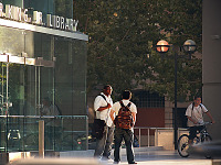 san-jose-state > Two males talking in front of Martin Luther King, Jr Library at SJSU